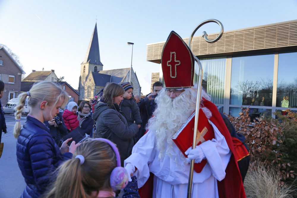 Sinterklaas groet de kinderen bij zijn aankomst aan 't IJzeren Hekken